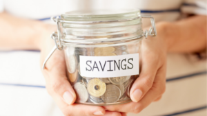Hands holding a jar of coins representating the savings of working with an independent insurance agent